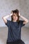 Attractive woman wearing blue t-shirt and black pants while sitting on floor in comfort pose