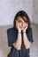 Attractive woman wearing blue t-shirt and black pants while sitting on floor in comfort pose