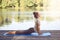 Attractive woman working out on a wooden deck