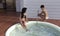 Attractive women chatting next to a hot tub