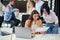 Attractive worker consulting with her office manager and signing financial document at her workplace.