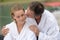 attractive youg couple in white bath-robes on terrace