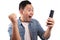 Attractive young Asian man have good news on his phone, happy laughing winning expression