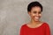 Attractive young black woman in red shirt smiling