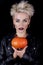 Attractive young blond woman with a pumpkin in the hands