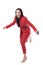 Attractive young business woman in red suit and high heels stumbling and falling.