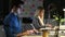 Attractive young businessman working with laptop in conference room at modern startup at night.