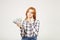 Attractive young businesswoman posing with bunch of USD cash in hands showing positive emotions and happy facial expression.