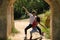 Attractive young couple dancing sensual bachata under an ancient stone arch in an outdoor park. Latin, sensual, folkloric, urban