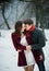 Attractive young couple in love in the snowy Park