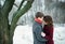 Attractive young couple in love in the snowy Park