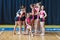 Attractive young dancers in black and pink suit on the background of the gym, group of cheerleaders getting ready to do the trick