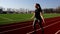 Attractive young fit active athlete girl jumping with skipping rope working out warming up at big stadium in slow motion