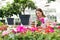 Attractive young girl buying impatiens plants