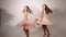 Attractive young girls twirling and whirling in studio with white background. Adorable and trendy slender models wearing