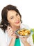 Attractive Young Hispanic Woman Holding a Plate of Seafood Linguine