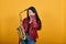 Attractive young keeping gold saxophone posing covering face with hand