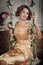 Attractive young lady on the flowered swings. Vertical.