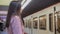 Attractive young lady waiting for train in subway, public transportation, city