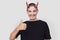 Attractive young man with halloween horns