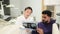 Attractive young man, sitting on dentist chair and looking at x-ray picture of scan image of teeth