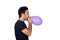 Attractive young men swelling a purple balloon