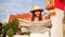 Attractive Young Mixed Race Tourist Hipster Woman in White Dress and Big Straw Hat with City Map Looking Around in Thai