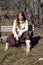 Attractive young redhead sitting on a bench