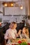 Attractive young single mother making a salad in the kitchen with her daughter