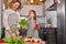 Attractive young single mother making a salad in the kitchen with her daughter