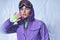 attractive young woman in balaclava, purple