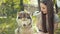 Attractive Young Woman With Brown Eyes, Brunette Feeds Siberian Husky Dog.