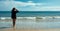 Attractive young woman in casual style fashion at the seaside enjoying the warm breeze