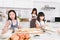 Attractive young woman and dauther cute daughter are cooking on a kitchen