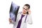 Attractive young woman doctor looking at x-ray holding magnifier near her head making diagnosis in white uniform on