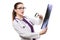 Attractive young woman doctor looking at x-ray making diagnosis in white uniform on white background