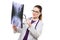 Attractive young woman doctor looking at x-ray making diagnosis in white uniform on white background