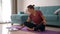 An attractive young woman doing meditation while working from home.