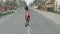 Attractive young woman in a dress with flowers walking on the highway