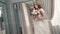 Attractive young woman dressed in wedding dress posing for bridal photo session in studio.