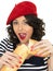 Attractive Young Woman Eating a French Stick Bread Loaf