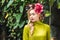 attractive young woman with floral wreath with green rainforest