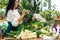 Attractive young woman florist is working in a flower shop.