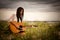 Attractive Young Woman With Guitar on Beach