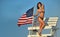 Attractive young woman with perfect slim fit body in bikini posing on the lifeguard tower.