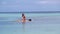 Attractive Young Woman Stand Up Paddle Surfing, Beautiful Tropical Ocean