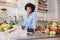 Attractive young woman standing at juice bar counter