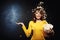 Attractive young woman staying under popcorn shower with hand up