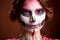 Attractive young woman with sugar skull halloween makeup