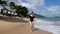 Attractive young woman walking on the beach. Cute girl have fun and enjoying tropical holidays. Beautiful girl enjoying
